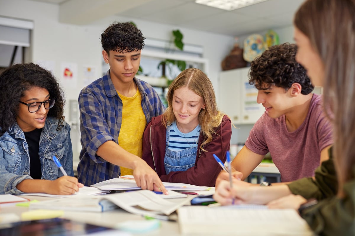 Diverse teenagers collaborating during a study session in classroom
