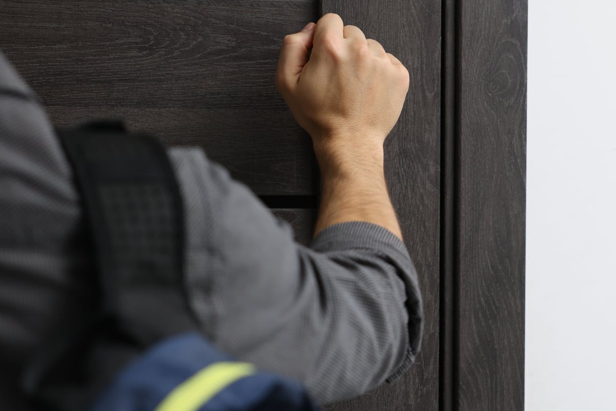 Community organizer engaging with a resident at their front door